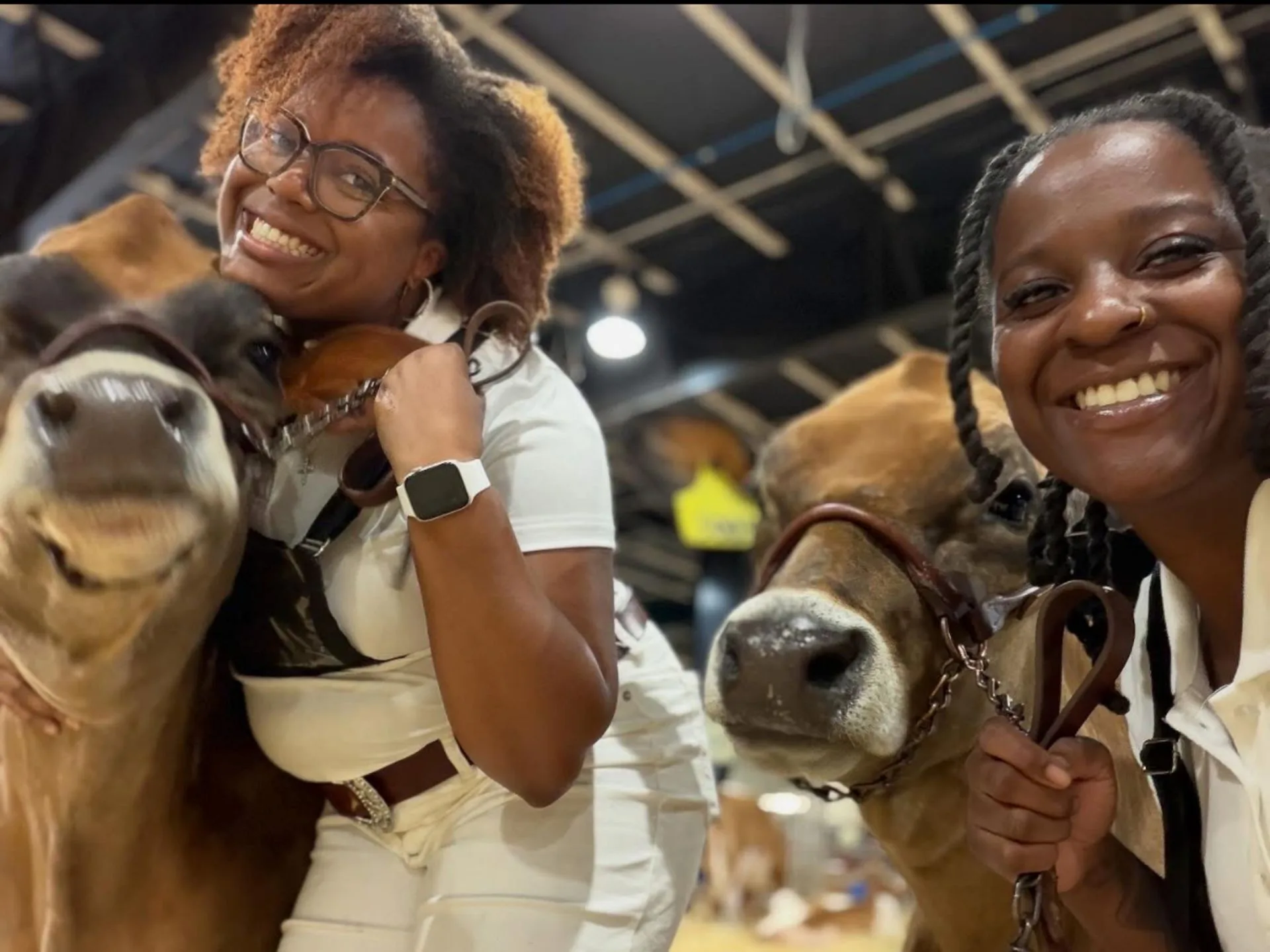 Erika Pearsall and Alysse Givan with their heifers at the 2025 N.C. State Fair.